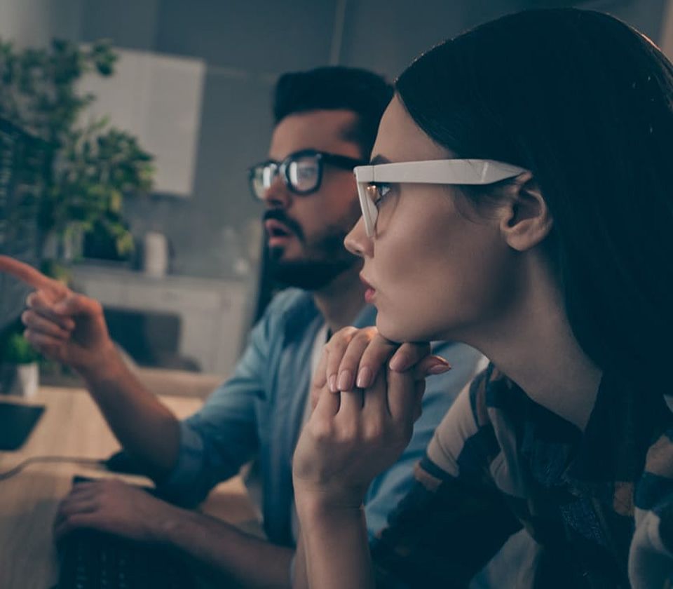 two people looking at a screen